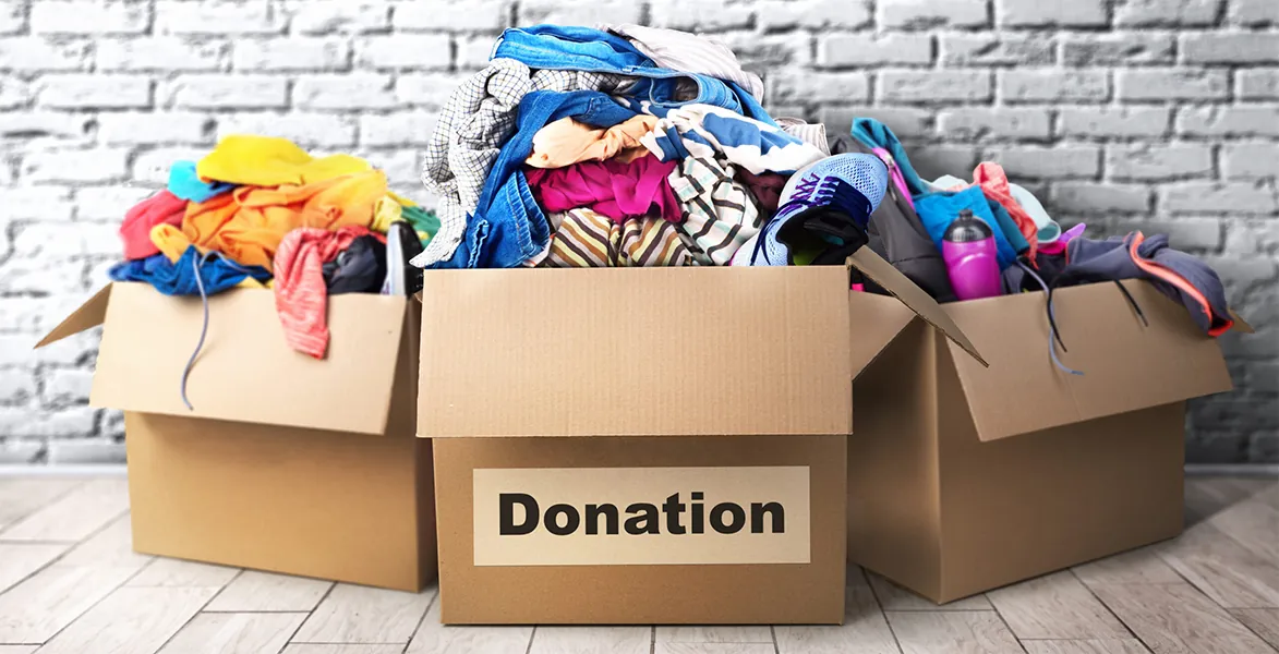 Cardboard donation boxes overflowing with clothes